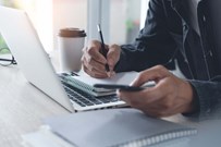 Person with laptop and notepad Person with laptop and notepad