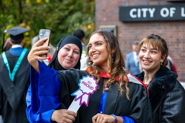 3 female family members including one graduand taking a selfie at the Barbican centre