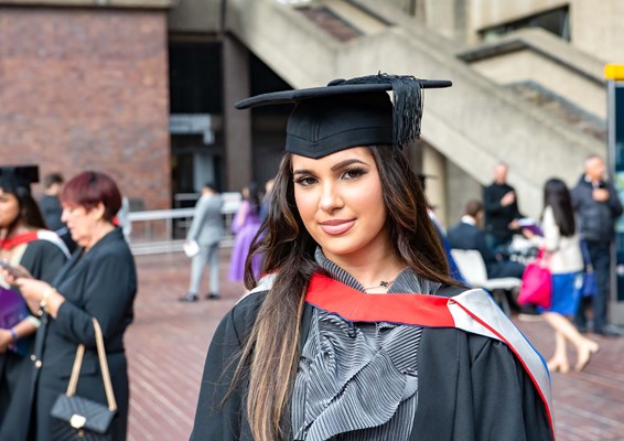 Female in gown outside at graduation at the Barbican Centre